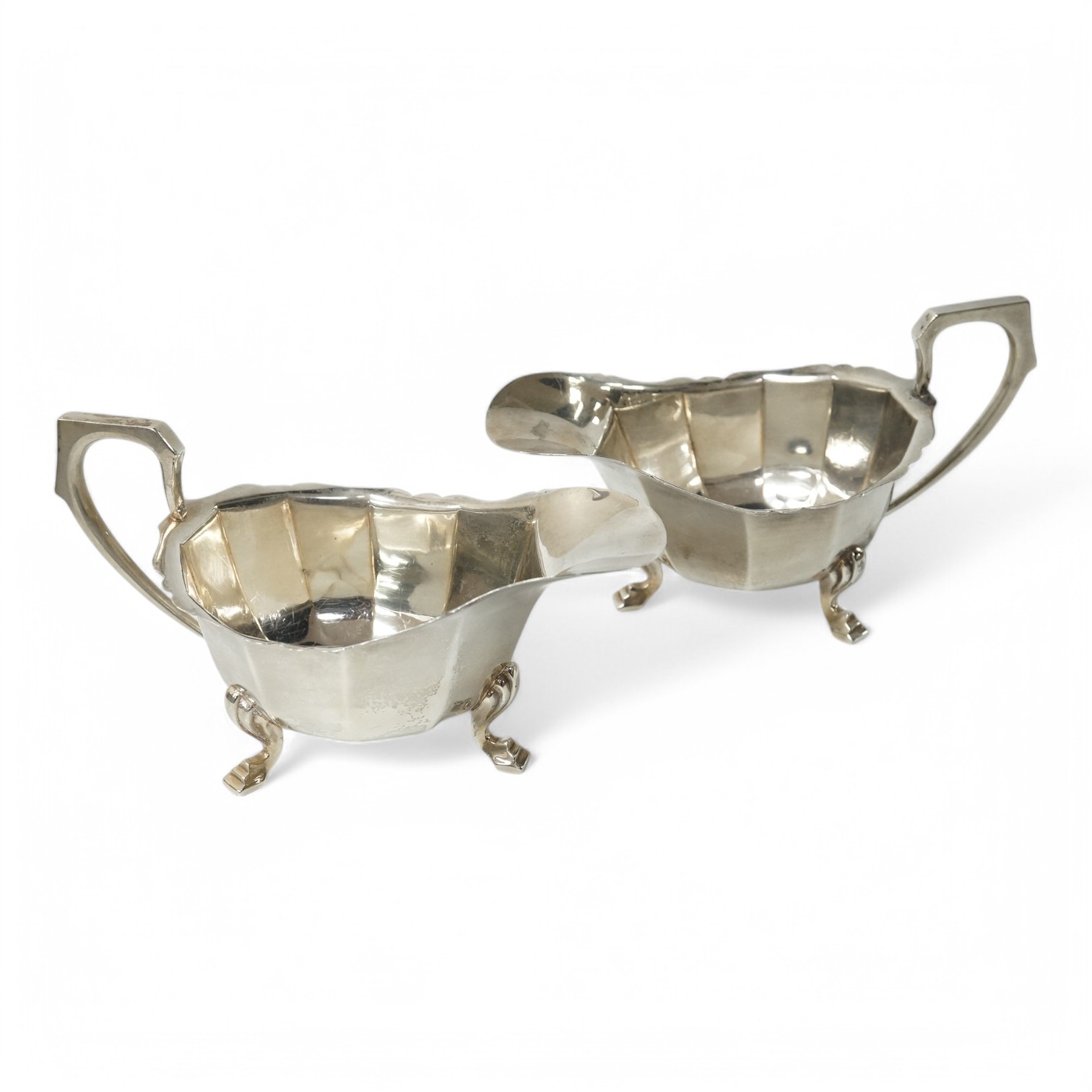 A pair of George VI silver sauce boats by Goldsmiths & Silversmiths Co Ltd, London, 1940, length 16.3cm, 9oz. Condition - fair to good